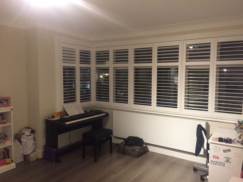 Hardwood plantation shutters. Made to measure and fitted to this London games room and lounge area.
